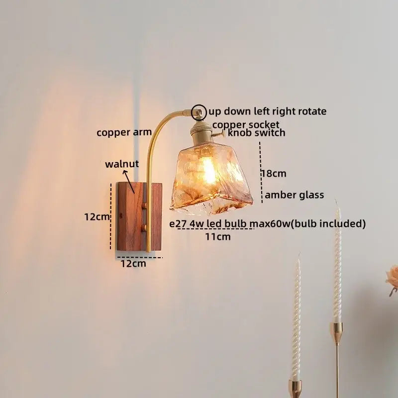 A warm amber modern ribbed glass wall light with a curved copper arm and ceramic walnut led base for bedroom decorbites