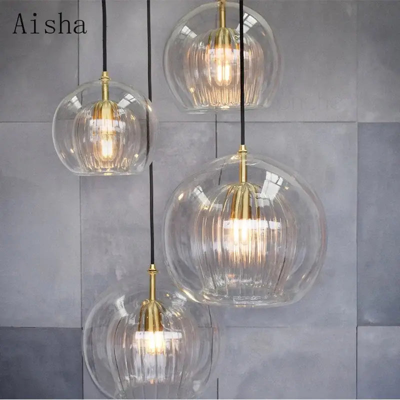 Modern ribbed glass ball led pendant lights with clear glass and gold-toned metal fixtures for kitchen decorbites glass ball