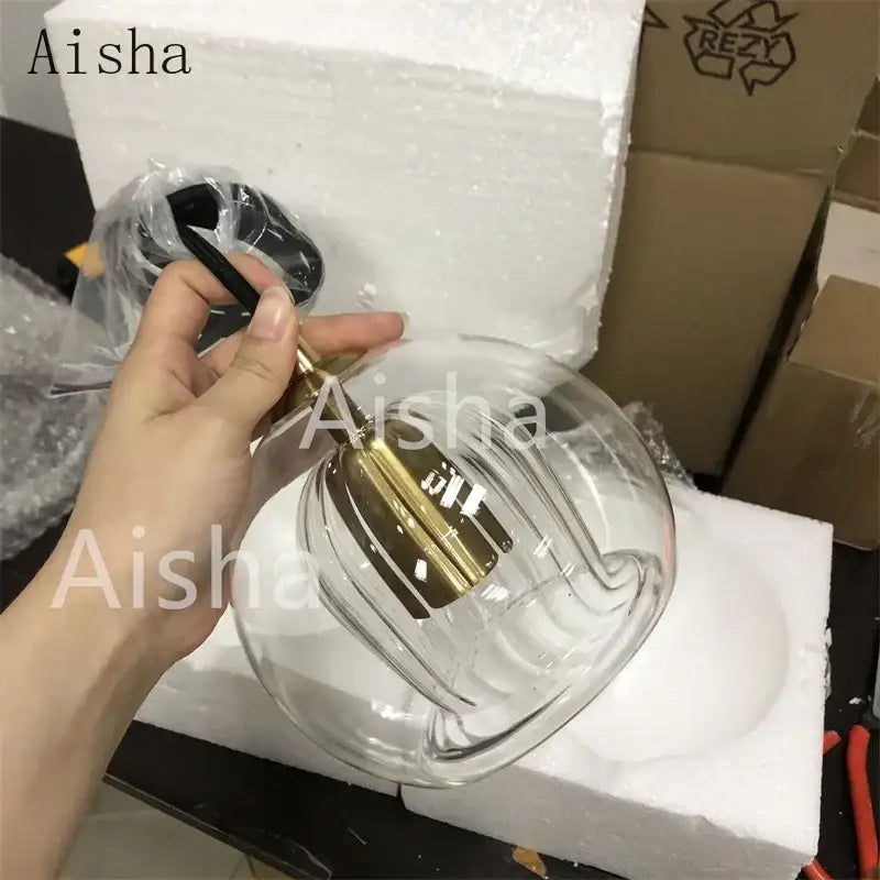 Clear glass pendant light with gold-toned metal fixture and decorative bands for modern kitchen decorbites glass ball led
