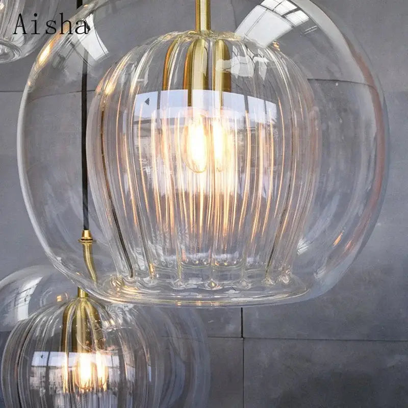 Modern ribbed glass ball led pendant light with clear vertical ribbed glass and gold-toned metal accents for kitchen decorbites pendant lights