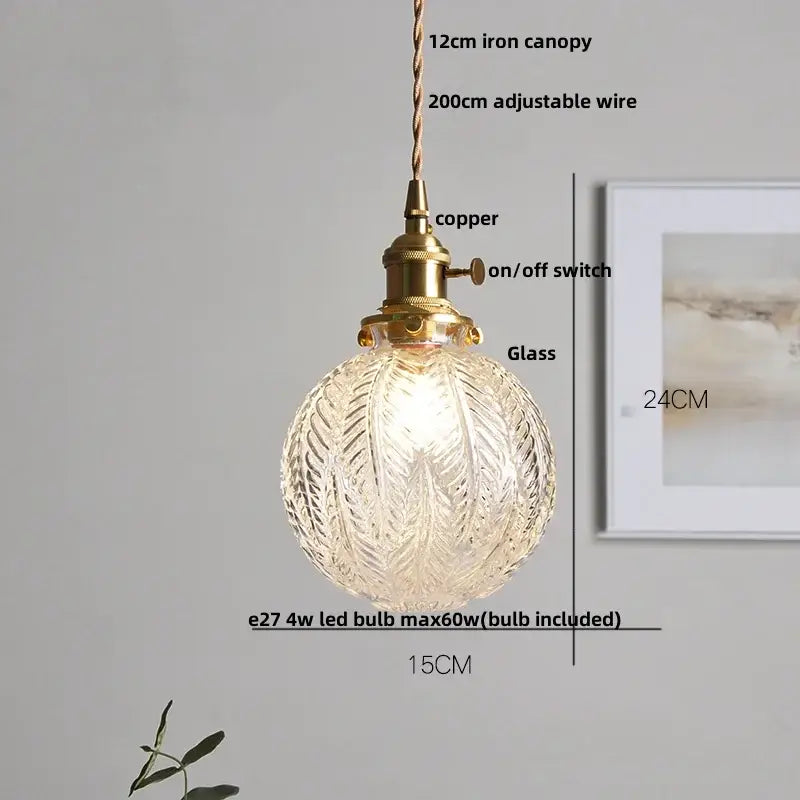 Modern ribbed glass brass led pendant light with intricately etched globe and iron canopy for dining room decorbites brass led
