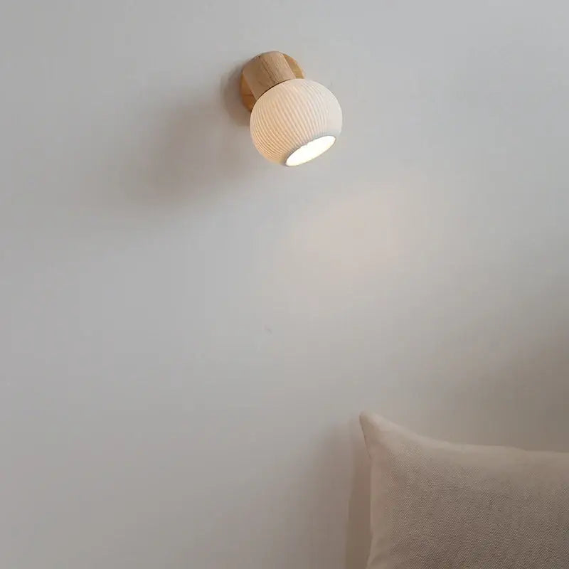 Modern ribbed glass ceramic led wall light with warm white ceramic globe and natural wood base for decorbites ceramic led wall decor