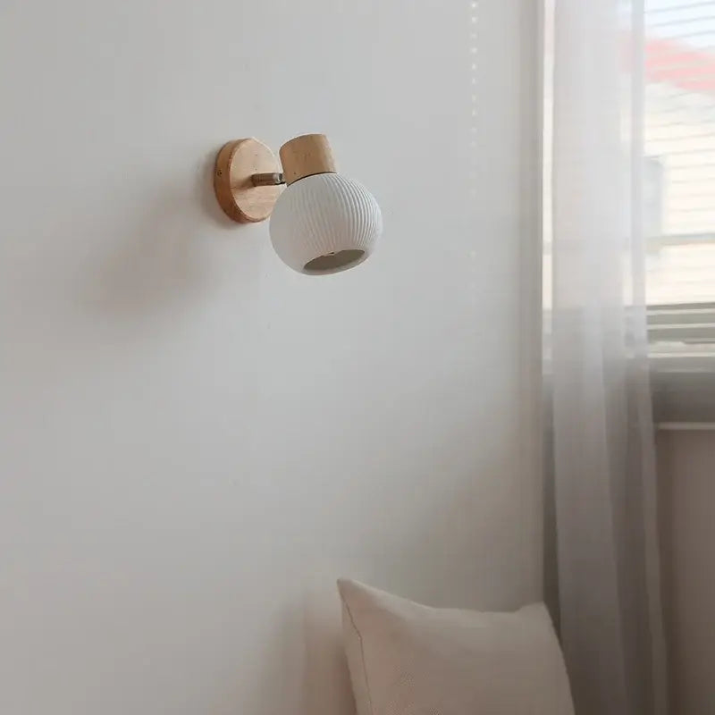 Modern ribbed ceramic led wall lights with white globe and natural wood finish base for bedroom decorbites ceramic led use