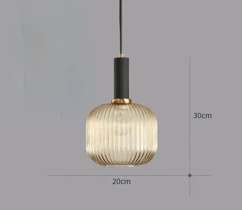 A modern light chandelier featuring a ribbed amber glass colorful led pendant with black and gold-toned metal accents