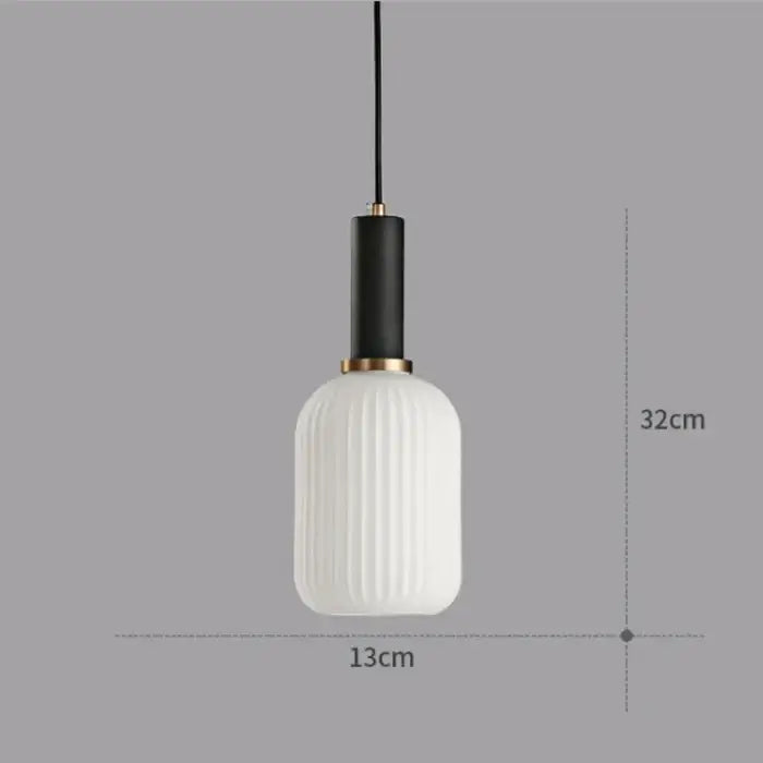A modern pendant light chandelier with a white ribbed glass shade black stem and gold-toned accents for dining rooms