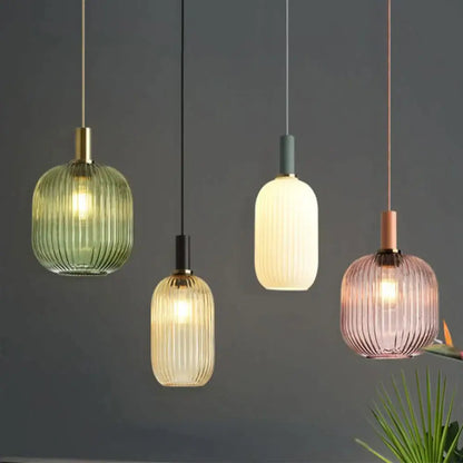 Four modern light chandeliers with ribbed glass colorful led shades in green amber cream and pink hues for dining rooms