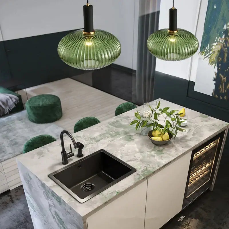 Green ribbed glass colorful led pendants with black and gold fixtures hang as modern light chandeliers above kitchen island