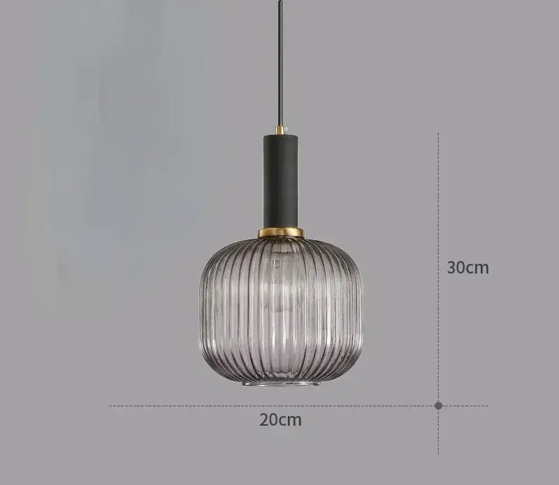 A modern light chandelier with a ribbed smoked glass colorful led globe and black shade with gold hardware