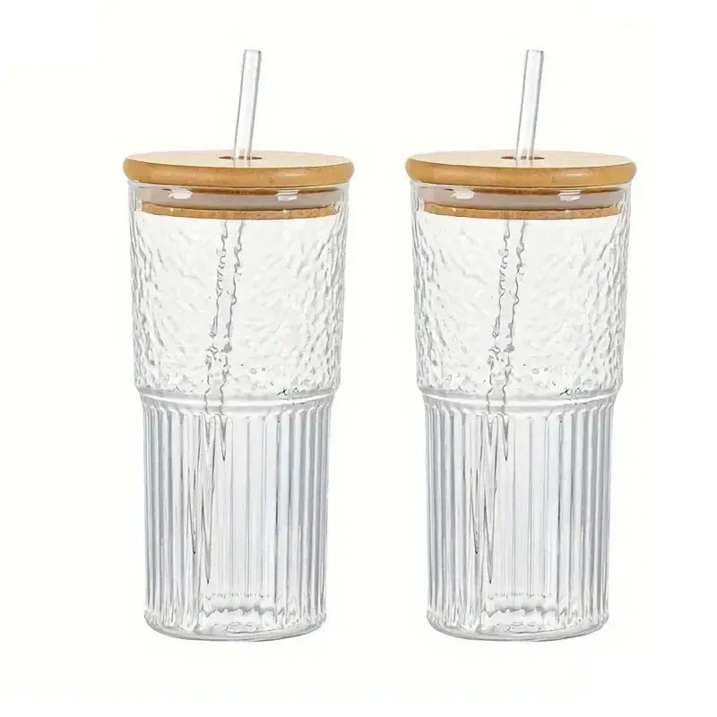 Modern ribbed glass cup with clear textured ribbed glass sides bamboo lid and clear straw for kitchen drinking use