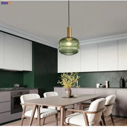 Modern green ribbed glass pendant light with brass-finished metal fixture ideal for dining room pendant lights