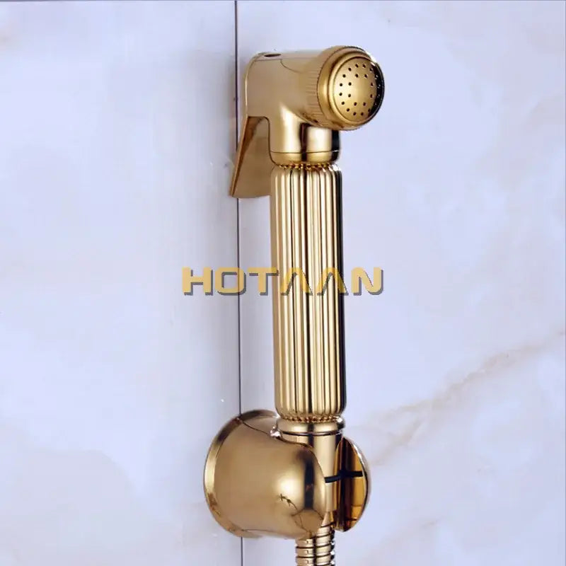 Modern ribbed gold brass bidet sprayer set featuring a gold-colored handheld bidet sprayer with a sleek metallic finish