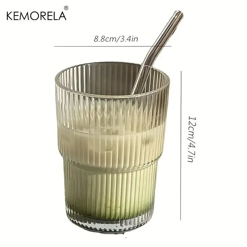 A modern ribbed stripe glass cup with lid and straw featuring a green to clear gradient liquid and stainless steel straw