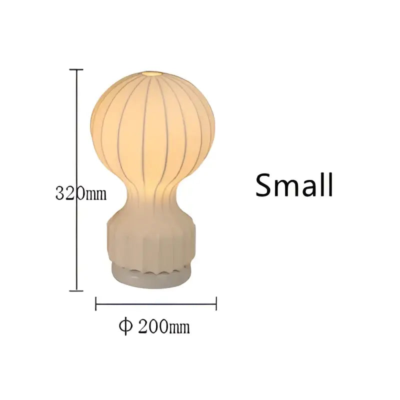 Beige hot air balloon shaped silk table lamp with ribbed white ceramic design and textured base for bedroom use
