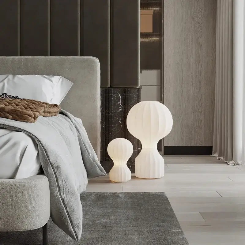 Two white ribbed ceramic silk table lamps with modern organic design beside the bed for bedroom use