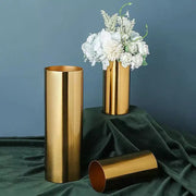Modern ridged gold plated cylinder vase with sleek metallic finish holding white flowers for living room decorbites gold plated