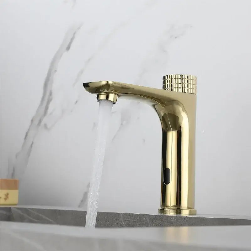 Modern ridged gold sensor mixer faucet with textured knob and flowing water for bathroom sink use