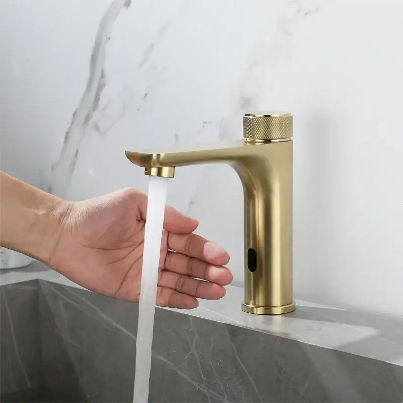 Modern ridged gold sensor mixer faucet featuring a touchless single-handle design with a textured knob for bathroom sinks