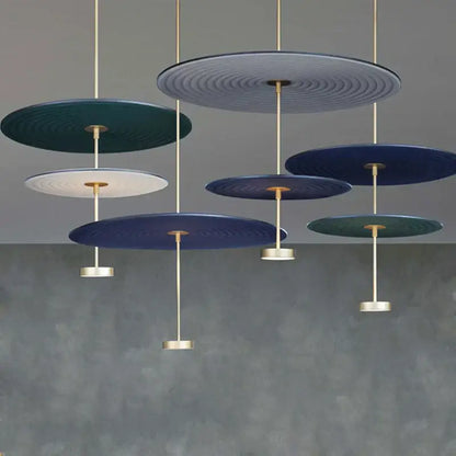 Modern ripple cotton round pendant lights featuring concentric teal navy and white patterns with gold rods for living room decor