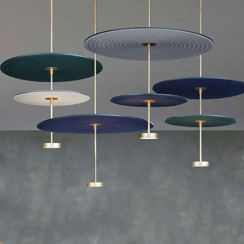 Modern ripple cotton round pendant lights featuring concentric teal navy and white patterns with gold rods for living room decor