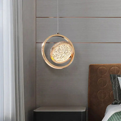Modern gold-toned pendant light featuring a sparkling crystal center with acrylic led chandelier design for dining rooms