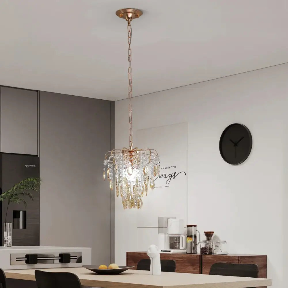 A delicate gold-toned decorbites crystal led pendant light with cascading amber crystal droplets for living room decor