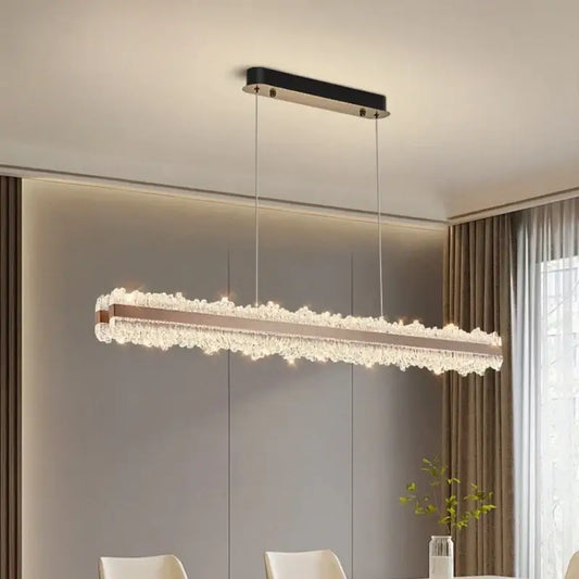 Modern rose gold and black crystal pendant light with sleek ceiling mount and brushed stainless accents for dining room use