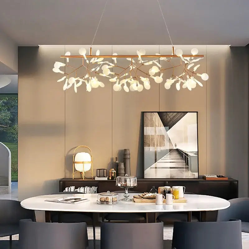 Modern rose gold pendant light with brass-toned branching arms and frosted glass globe light sources for dining room