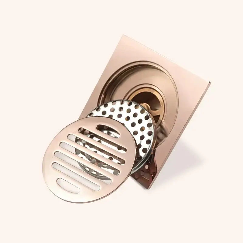 Modern rose gold brushed square floor drain with two removable polished metal grates for bathroom use