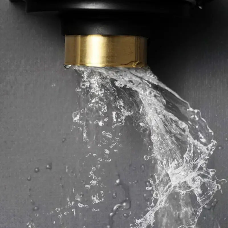 Modern rose gold brushed square floor drain with brass-finished faucet spout and black housing with flowing water