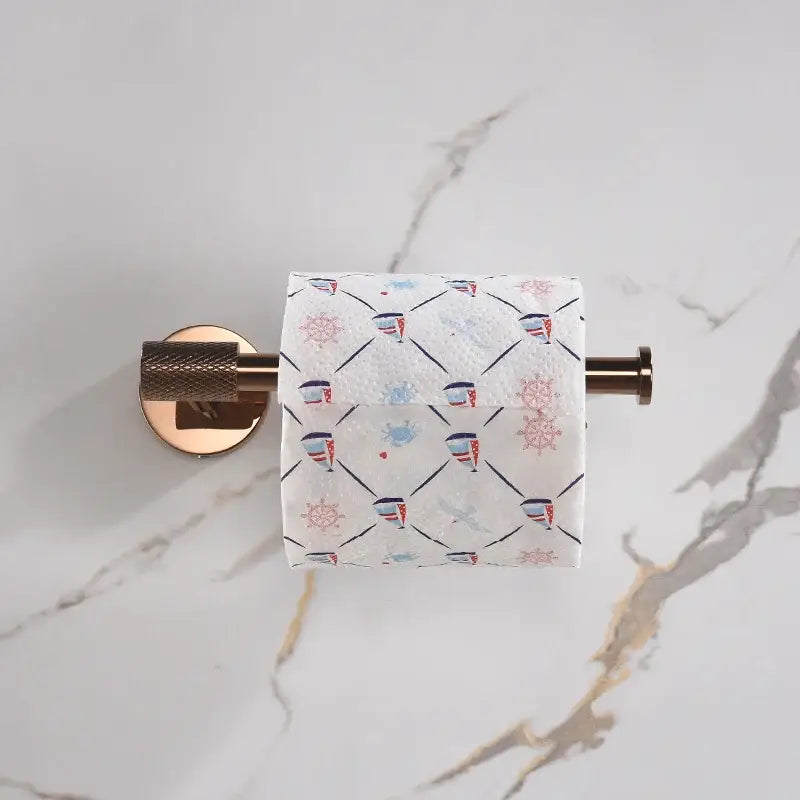 Modern rose gold and brushed gold stainless steel bathroom accessories with nautical-themed toilet paper featuring red and blue designs for decorbites bathroom