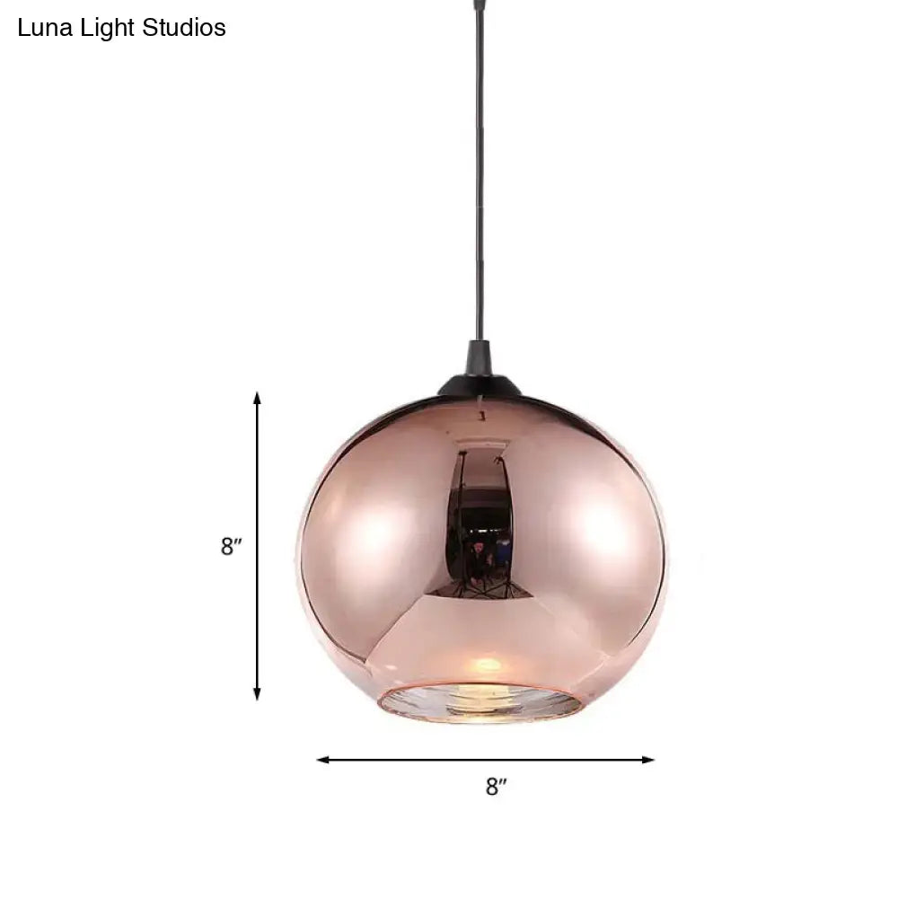 Modern rose gold copper sphere pendant light fixture with reflective glass shade and black cord for kitchen bar use