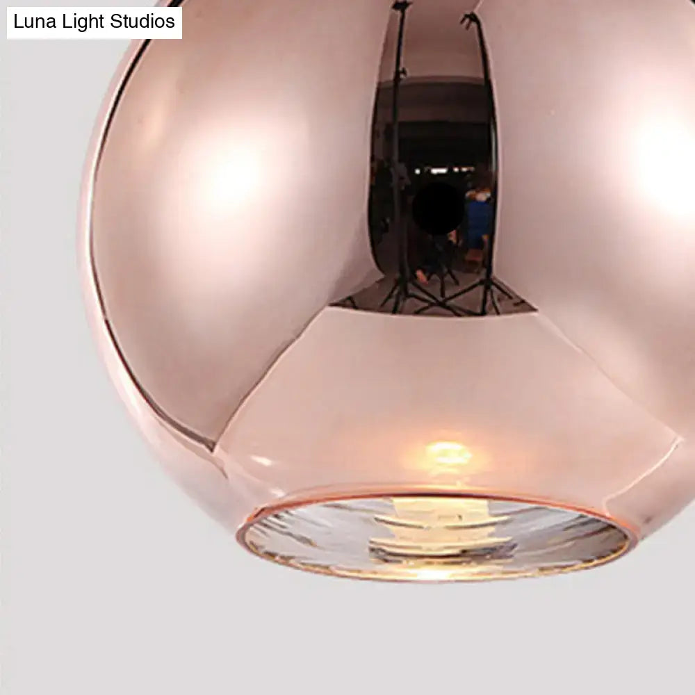 Modern rose gold copper sphere pendant light with frosted interior and reflective surface for kitchen bar use