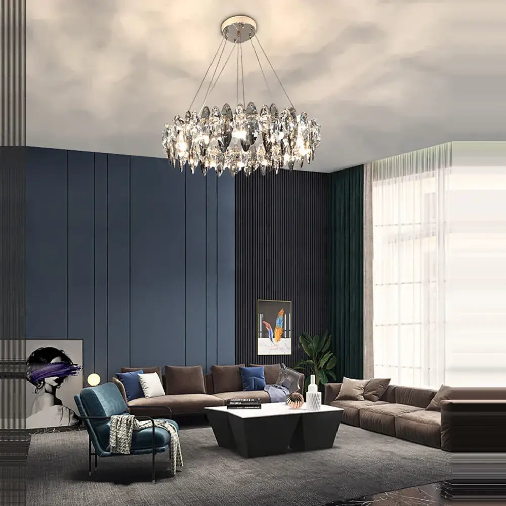 A modern rose gold crystal dimmable led pendant light with a circular design hangs in a dining room decorbites crystal dimmable