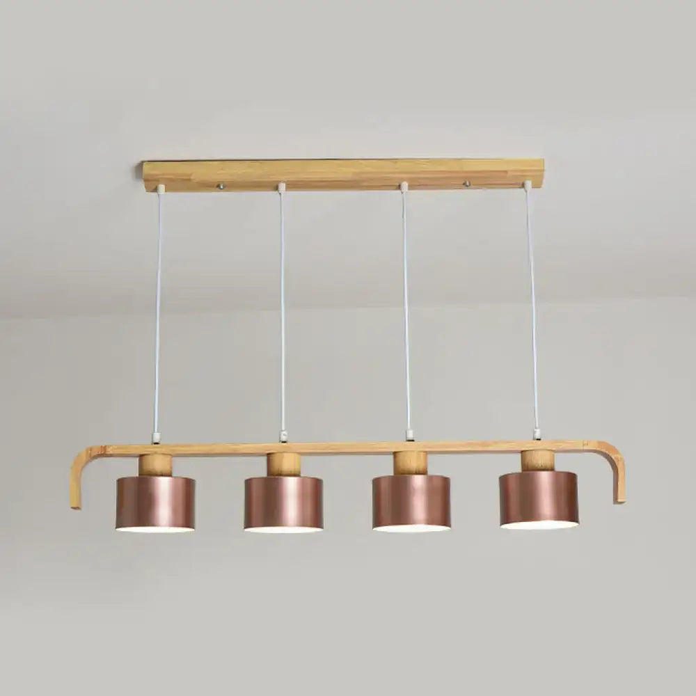 Modern rose gold drum island chandelier with copper-finished cylindrical pendant lights on light wood frame for dining table