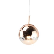 A modern rose gold and frosted glass ball pendant light featuring a polished spherical shade for kitchen decorbites