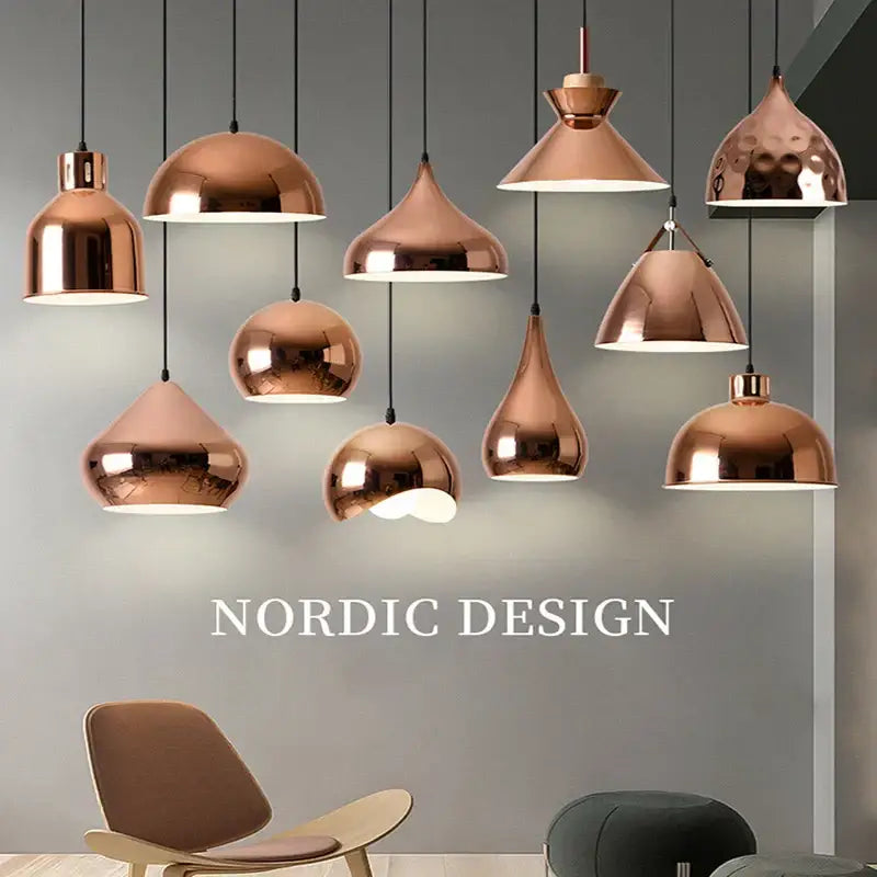 A collection of modern rose gold pendant lights with sleek copper-toned designs hanging from black cords decorbites rose gold