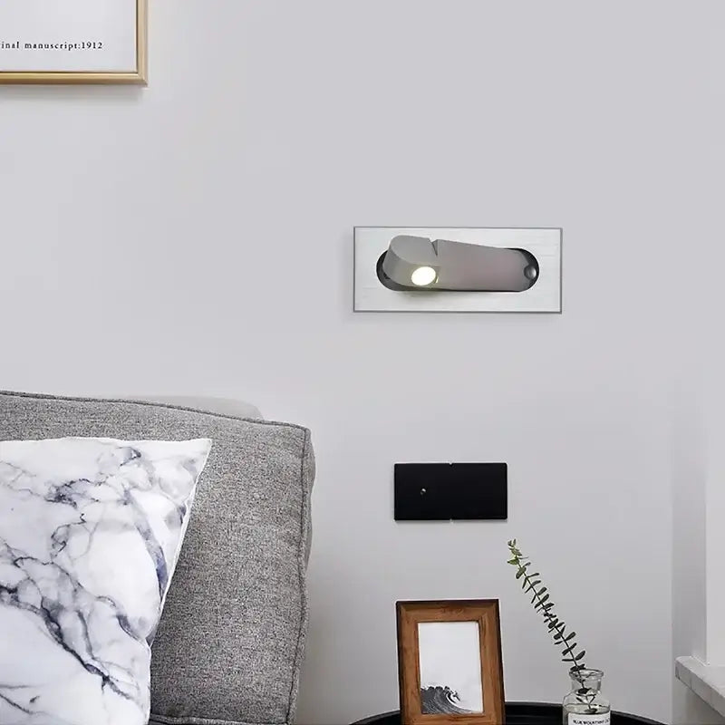 Modern rose gold and stainless steel led wall lamp with a sleek silver metallic finish and adjustable reading light head