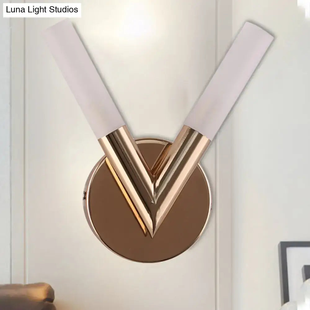 Modern rose gold v-shaped bedroom sconce with frosted white glass shade and brushed gold metal accents