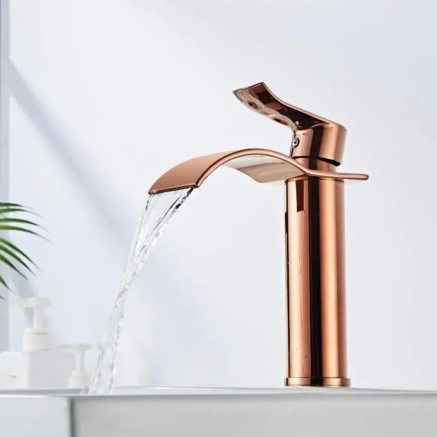 Rose gold waterfall faucet with a sleek, modern design and polished metallic finish.