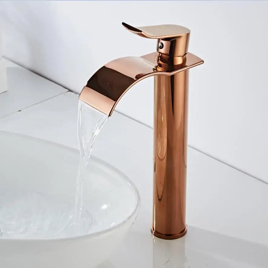 Modern rose gold single hole basin faucet with polished metallic housing material and sleek waterfall design