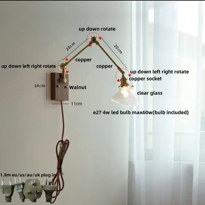 Adjustable copper wall light fixture with clear glass shade and walnut-finished base for modern stair lighting