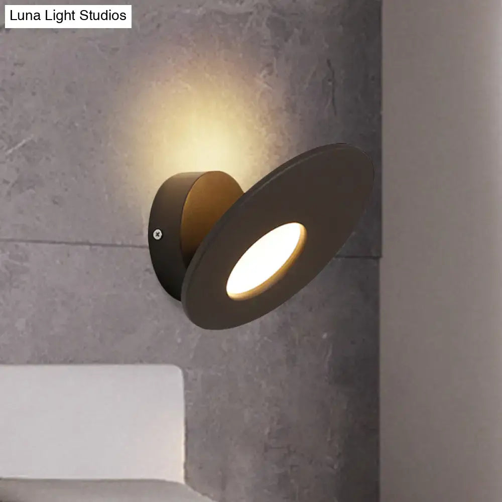 Modern round acrylic integrated led wall lamp in black matte with circular design and warm focused light for bedroom