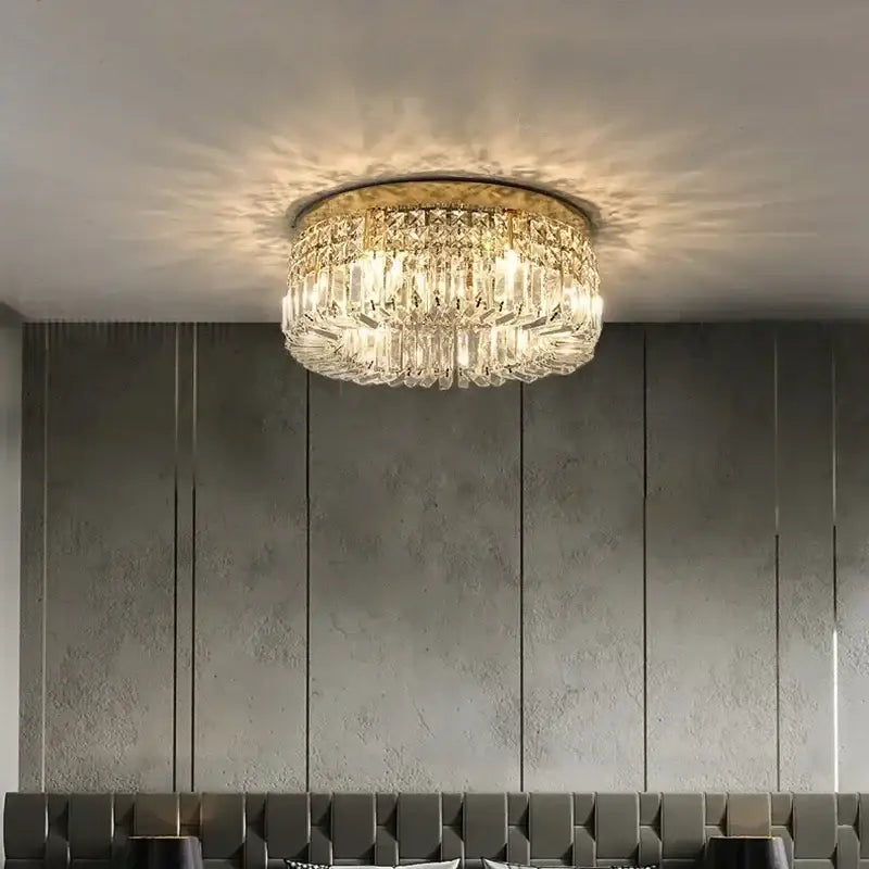 Modern round crystal led ceiling light featuring a gold-toned metal frame and cascading clear crystals decorbites crystal led ceiling