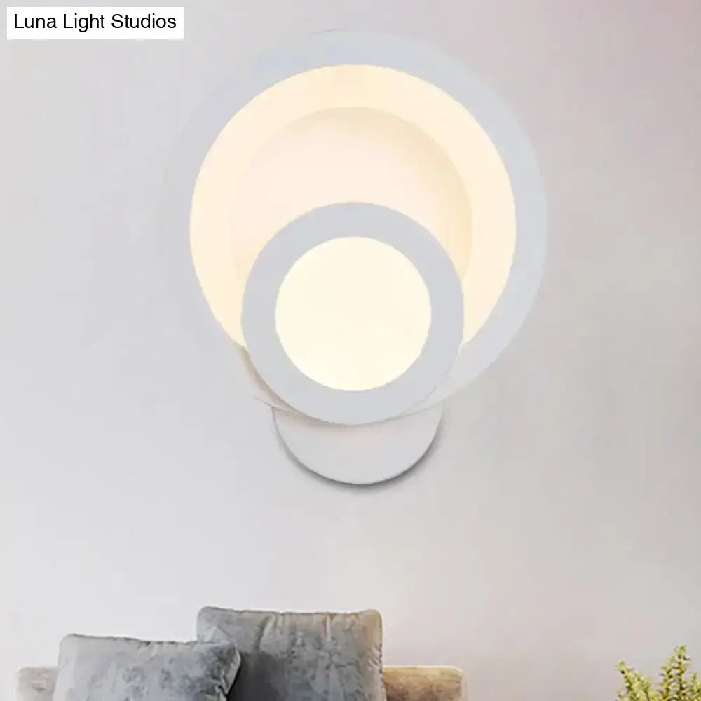 Modern round white led wall light with concentric rings emitting warm white light for stairway use