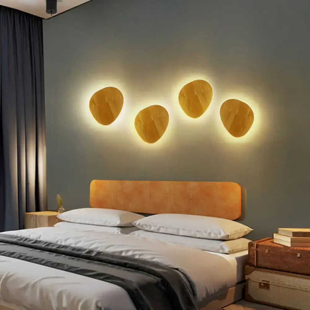 Four warm-toned oval wood grain led wall lighting fixtures emitting ambient light for modern living room decor