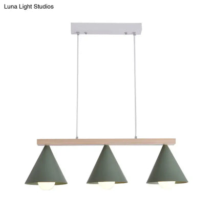 Modern DecorBites™ green iron island pendant ceiling light with three matte sage green conical shades on wood beam