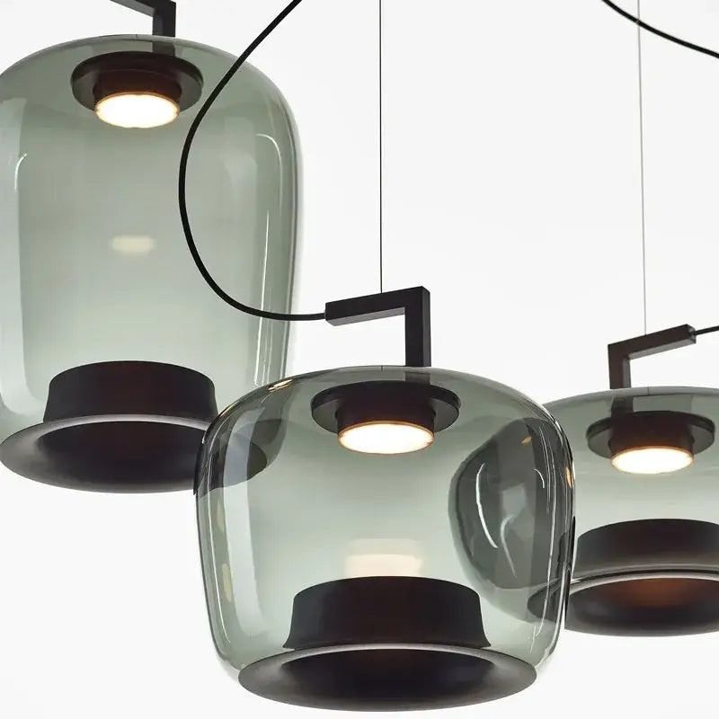 Modern sage green brokis glass pendant lamp with frosted glass shades and dark metal fixtures for dining room decorbites brokis glass