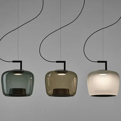 Modern sage green brokis glass pendant lamp with three curved black cords and muted green amber frosted shades for dining room decorbites brokis glass