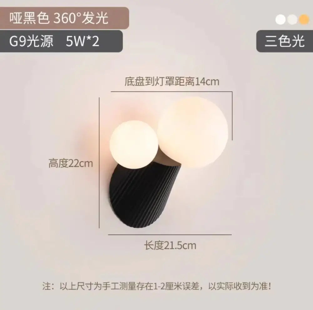 Black textured wall lamp with two glowing spherical lights featuring decorbites cactus resin glass accents for bedroom