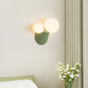Modern sage green decorbites cactus resin glass wall lamp with two glowing spherical bulbs and textured base for bedroom